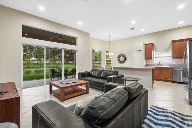 tiled living room featuring sink and an inviting chandelier