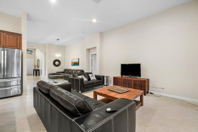9587 Positano Way, Lake Worth, FL 33467 - living room with arched walkways, light tile patterned floors, and baseboards