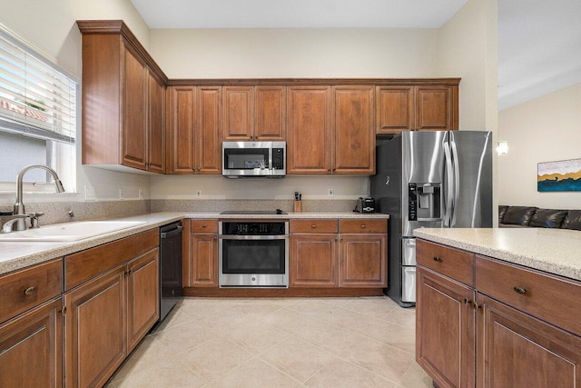 9587 Positano Way, Lake Worth, FL 33467 - kitchen featuring black appliances, a sink, light countertops, and brown cabinets
