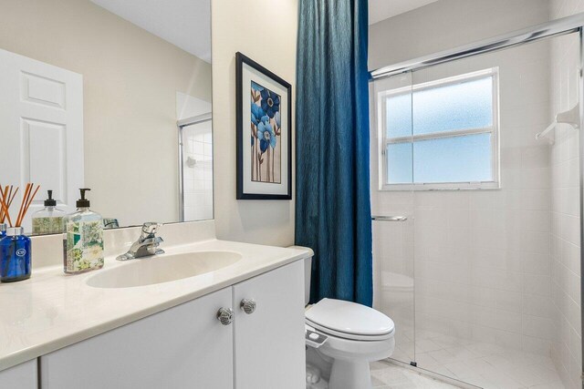 bathroom featuring vanity, toilet, and a shower with shower curtain