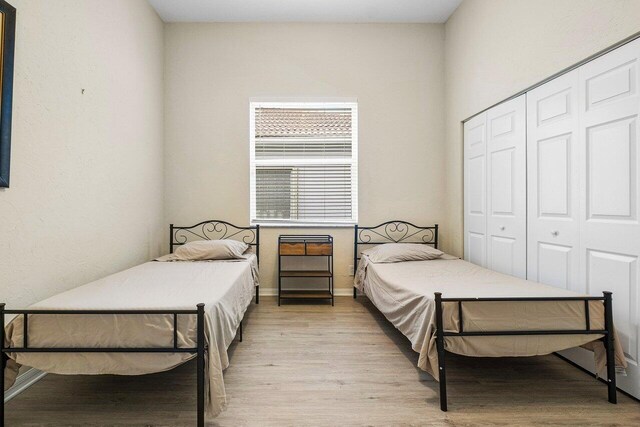 bedroom with a closet and light hardwood / wood-style floors