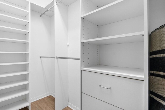 spacious closet featuring hardwood / wood-style floors