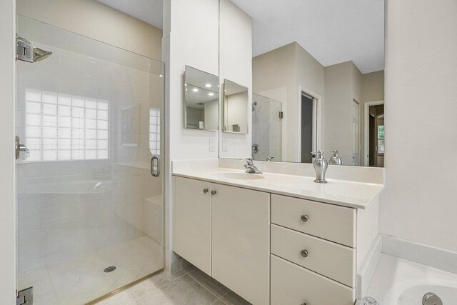 bathroom with vanity, tile patterned floors, and walk in shower