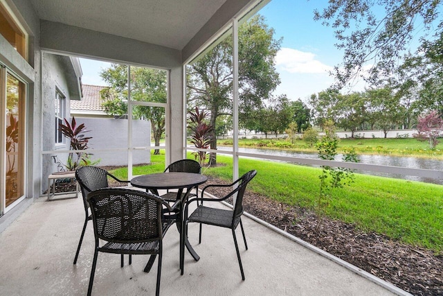 9587 Positano Way, Lake Worth, FL 33467 - sunroom with a water view and outdoor dining space