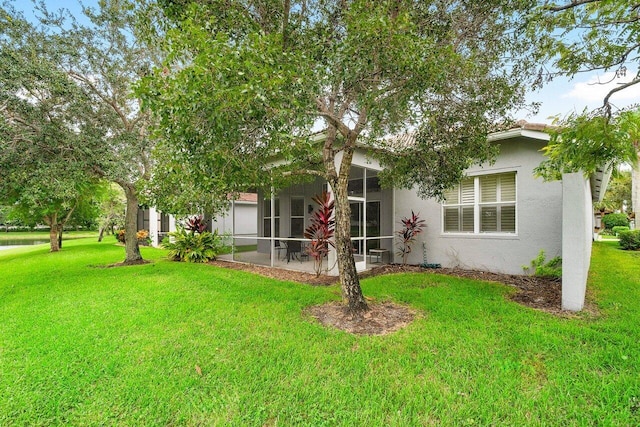 9587 Positano Way, Lake Worth, FL 33467 - back of house with stucco siding, a yard, and a sunroom