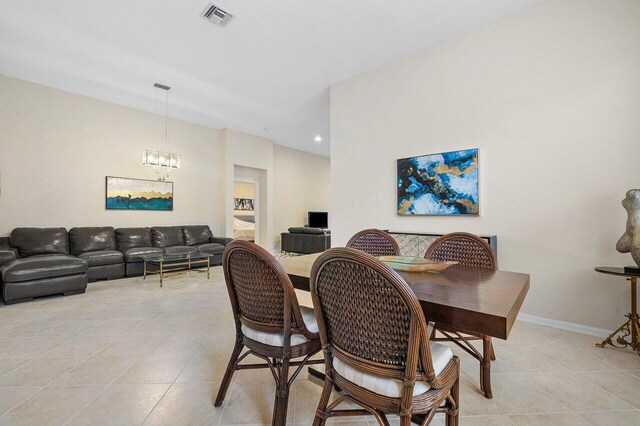 tiled dining space with a notable chandelier