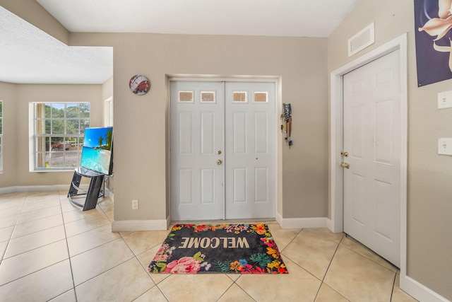 entryway featuring light tile patterned floors