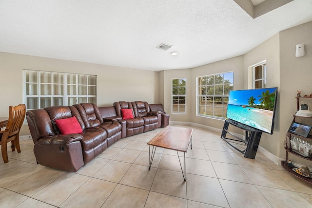 tiled living room featuring a textured ceiling