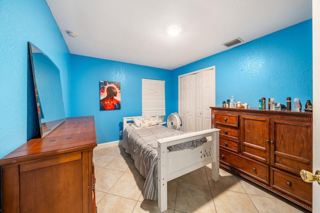 bedroom featuring a closet and light tile patterned flooring