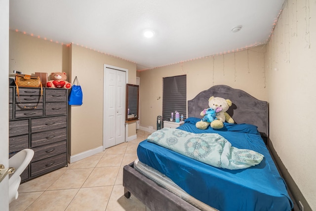 tiled bedroom featuring a closet