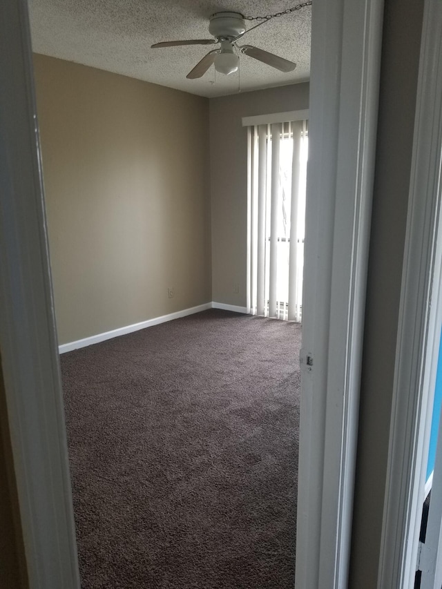 carpeted spare room with ceiling fan and a textured ceiling