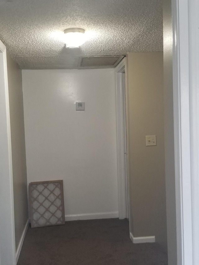 hallway featuring a textured ceiling