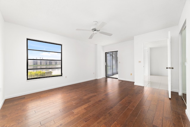 unfurnished room featuring dark hardwood / wood-style floors and ceiling fan