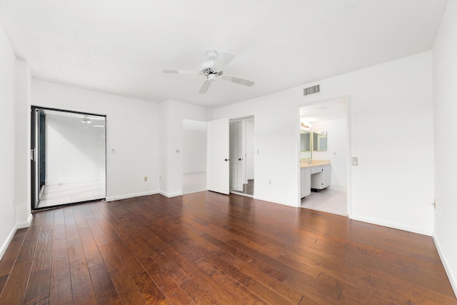 6093 Pointe Regal Cir Unit 106, Delray Beach, FL 33484 - unfurnished bedroom with hardwood / wood-style floors, baseboards, a ceiling fan, and ensuite bathroom