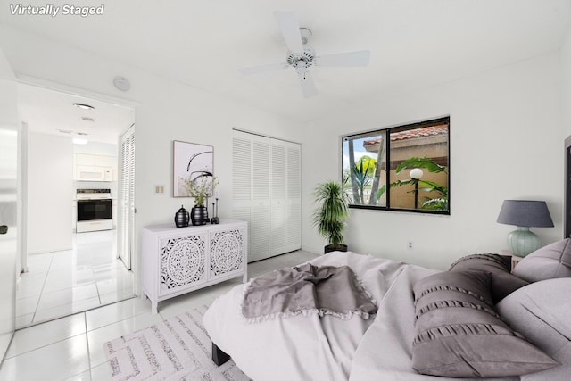 bedroom with a closet, ceiling fan, and light tile patterned flooring