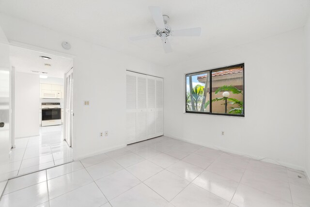 6093 Pointe Regal Cir Unit 106, Delray Beach, FL 33484 - spare room with a ceiling fan, light tile patterned flooring, baseboards, and a smoke detector