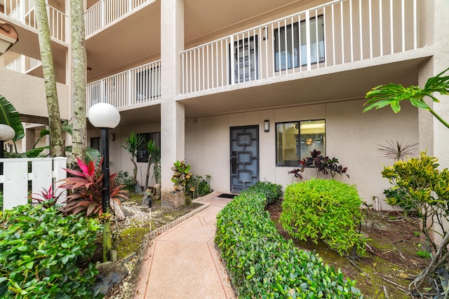 view of exterior entry featuring a balcony