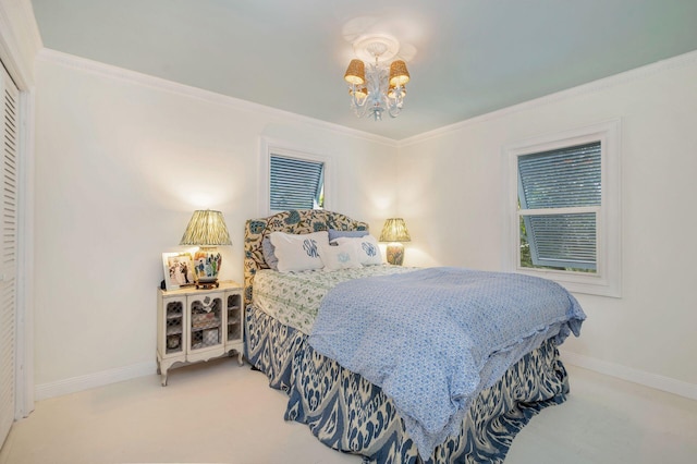 bedroom with a chandelier, crown molding, and carpet floors