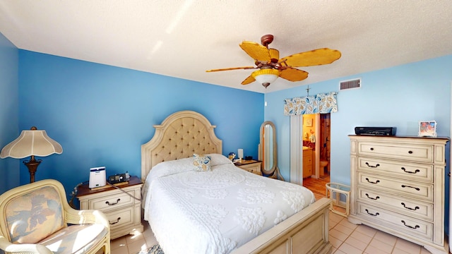 bedroom with a textured ceiling, light tile patterned floors, and ceiling fan