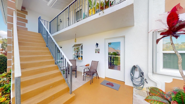 entrance to property featuring a patio area and a balcony