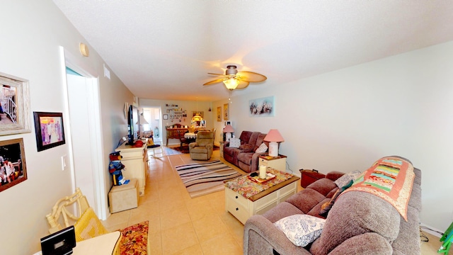 tiled living room with ceiling fan