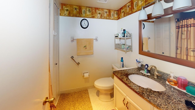 bathroom featuring vanity, toilet, and tile patterned flooring