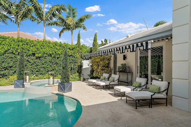 view of swimming pool featuring a patio area and an in ground hot tub