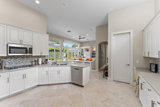 kitchen with ceiling fan, white cabinetry, kitchen peninsula, and appliances with stainless steel finishes