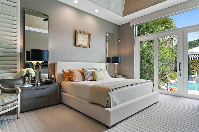 bedroom with access to outside and a high ceiling