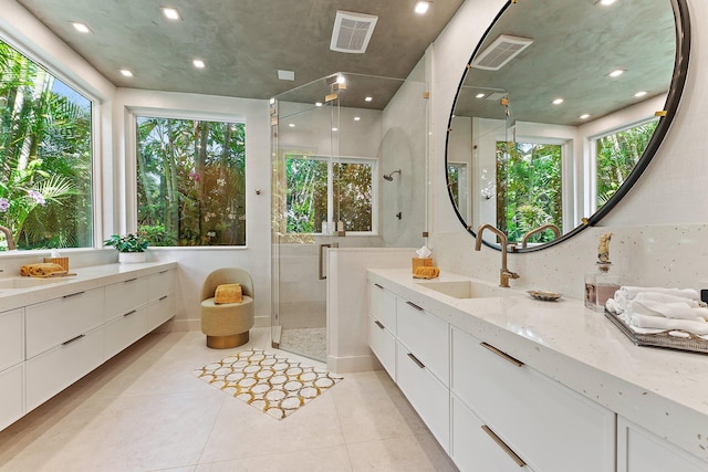 bathroom with vanity, tile patterned floors, and a shower with door