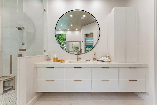 bathroom featuring a shower and vanity