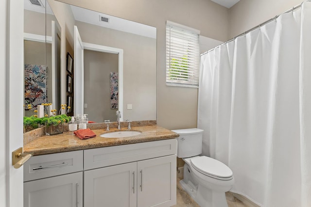 bathroom featuring tile patterned flooring, vanity, and toilet