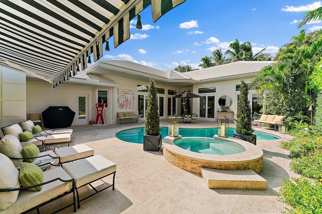 view of pool featuring a patio area, an in ground hot tub, and ceiling fan