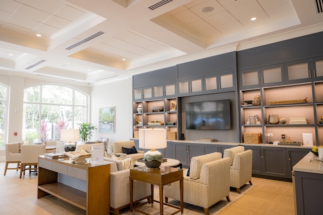 living room with light parquet floors, beam ceiling, and coffered ceiling