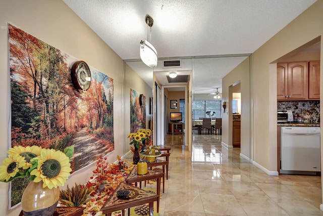 corridor featuring a textured ceiling