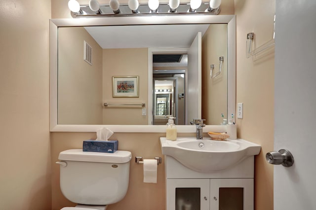 bathroom featuring toilet and vanity