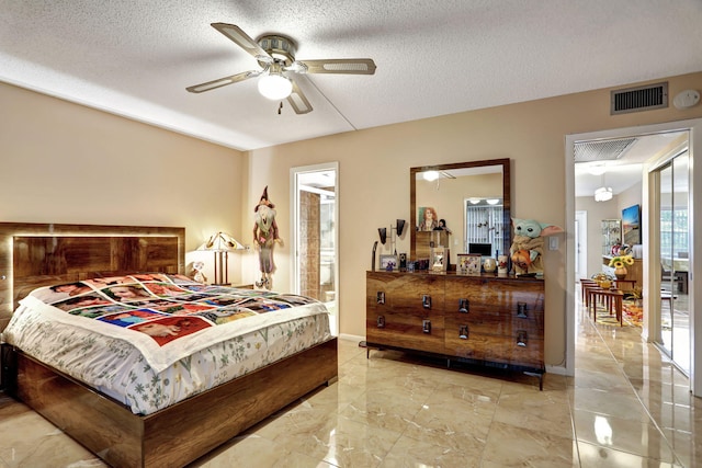 bedroom with connected bathroom, a textured ceiling, and ceiling fan