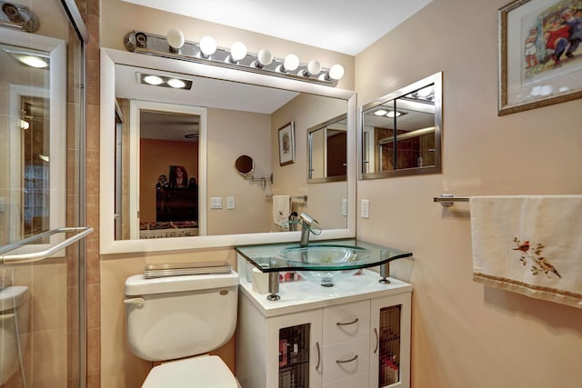 bathroom with vanity, toilet, and walk in shower