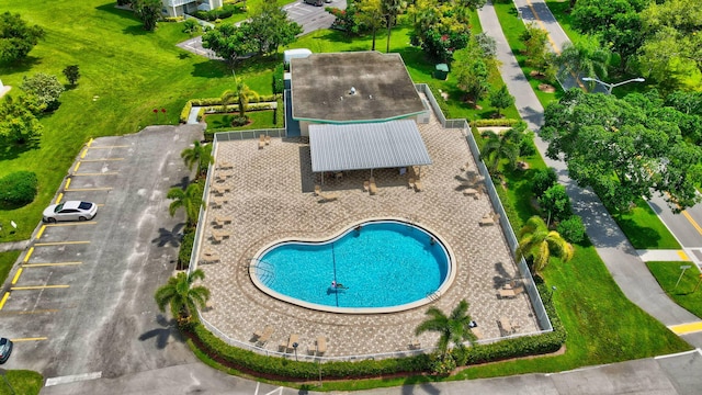 view of swimming pool with a patio and a yard