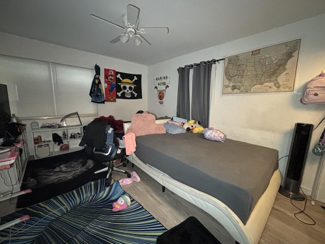 bedroom with light wood-type flooring and ceiling fan