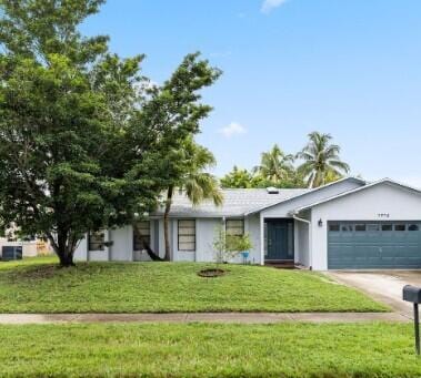 ranch-style house featuring a garage, driveway, and a front lawn