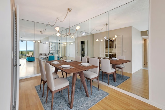 dining room with hardwood / wood-style floors and a chandelier