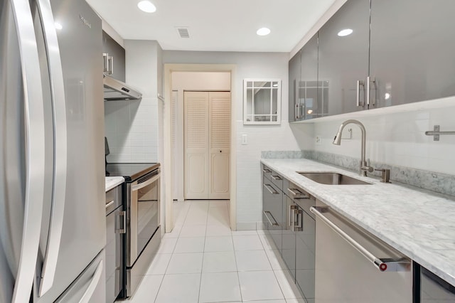 kitchen featuring light tile patterned floors, appliances with stainless steel finishes, sink, and gray cabinetry