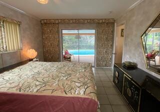 tiled bedroom with multiple windows and ornamental molding