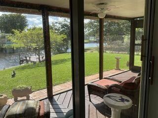 sunroom / solarium featuring a water view