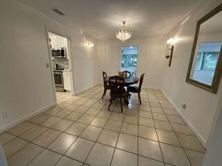 dining space featuring a chandelier and light tile patterned flooring