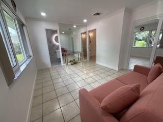 tiled living room featuring crown molding