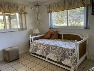 bedroom featuring light tile patterned flooring