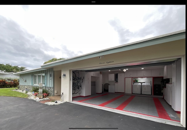 exterior space featuring a garage and washer / dryer