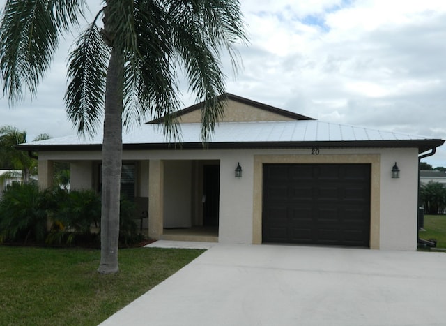 view of front of property featuring a front yard and a garage